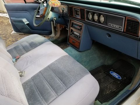 2001 Ford Crown Victoria - Photograph of a Ford LTD interior with dashboard, gauges, and bench seat; not a technical document.