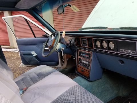 2001 Ford Crown Victoria - Photograph of a Ford LTD interior with steering wheel, dash, and open door; not a technical document.