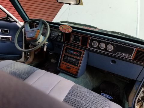2001 Ford Crown Victoria - Photo of a Ford LTD interior showing the dashboard, steering wheel and gauges, not a technical document.