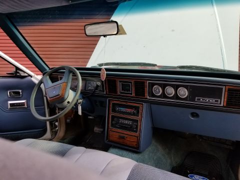 2001 Ford Crown Victoria - Photo of a Ford LTD interior dashboard and steering wheel, not a technical document.