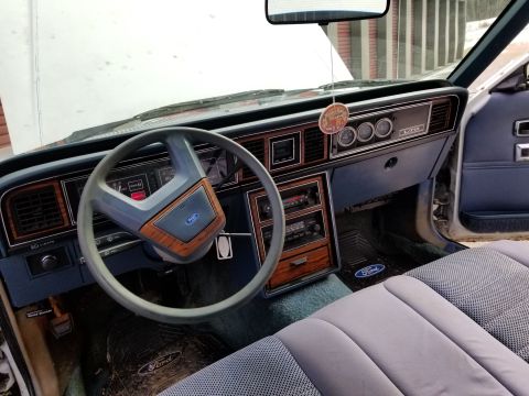 2001 Ford Crown Victoria - Photo of a Ford LTD interior showing steering wheel and dashboard, not a technical document.