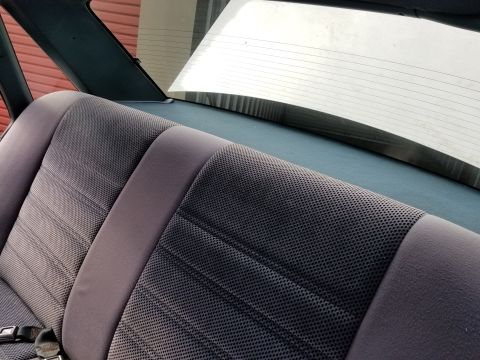 2001 Ford Crown Victoria - Photo of the rear bench seat and rear glass of a sedan interior, not a technical document.