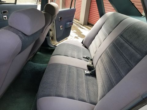 2001 Ford Crown Victoria - Photo of the gray cloth rear seats and interior of a sedan, not a technical document.