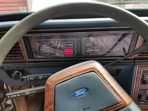 2001 Ford Crown Victoria - Photo of a Ford LTD instrument cluster and gauges through the steering wheel, not a technical document.