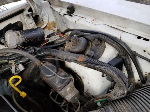2001 Ford Crown Victoria - Photo of an engine bay showing the brake master cylinder and wiring, not a technical document.