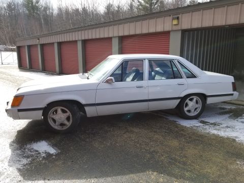 2001 Ford Crown Victoria - Photo of the side profile of a white Ford LTD sedan, not a technical document.