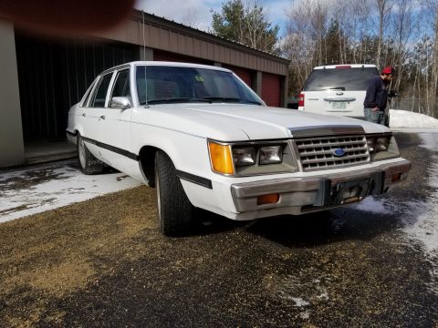 2001 Ford Crown Victoria - Photo of the front three-quarter view of a white Ford LTD sedan, not a technical document.