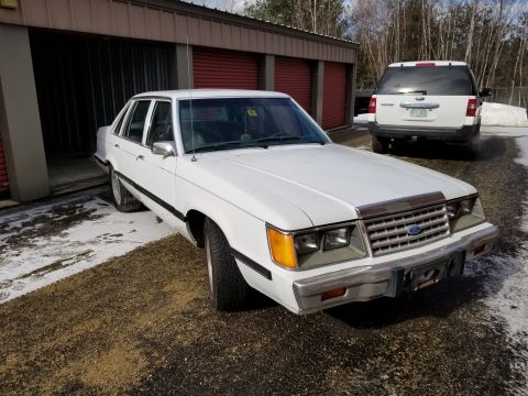2001 Ford Crown Victoria - Photo of the front of a white Ford LTD sedan, not a technical document.