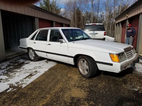 2001 Ford Crown Victoria - Photo of the front three-quarter of a white Ford LTD sedan, not a technical document.