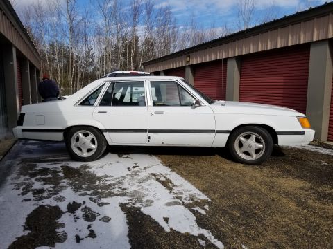 2001 Ford Crown Victoria - Photo of the side profile of a white Ford LTD sedan, not a technical document.