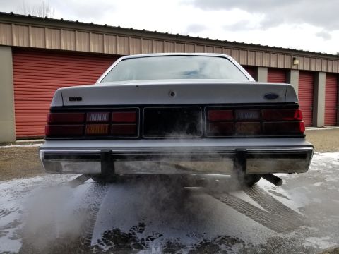 2001 Ford Crown Victoria - Photograph of the rear of a Ford sedan with visible exhaust, not a technical document.