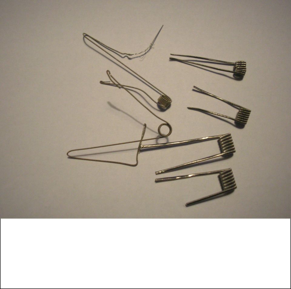 Several metal coils and wires on a gray surface