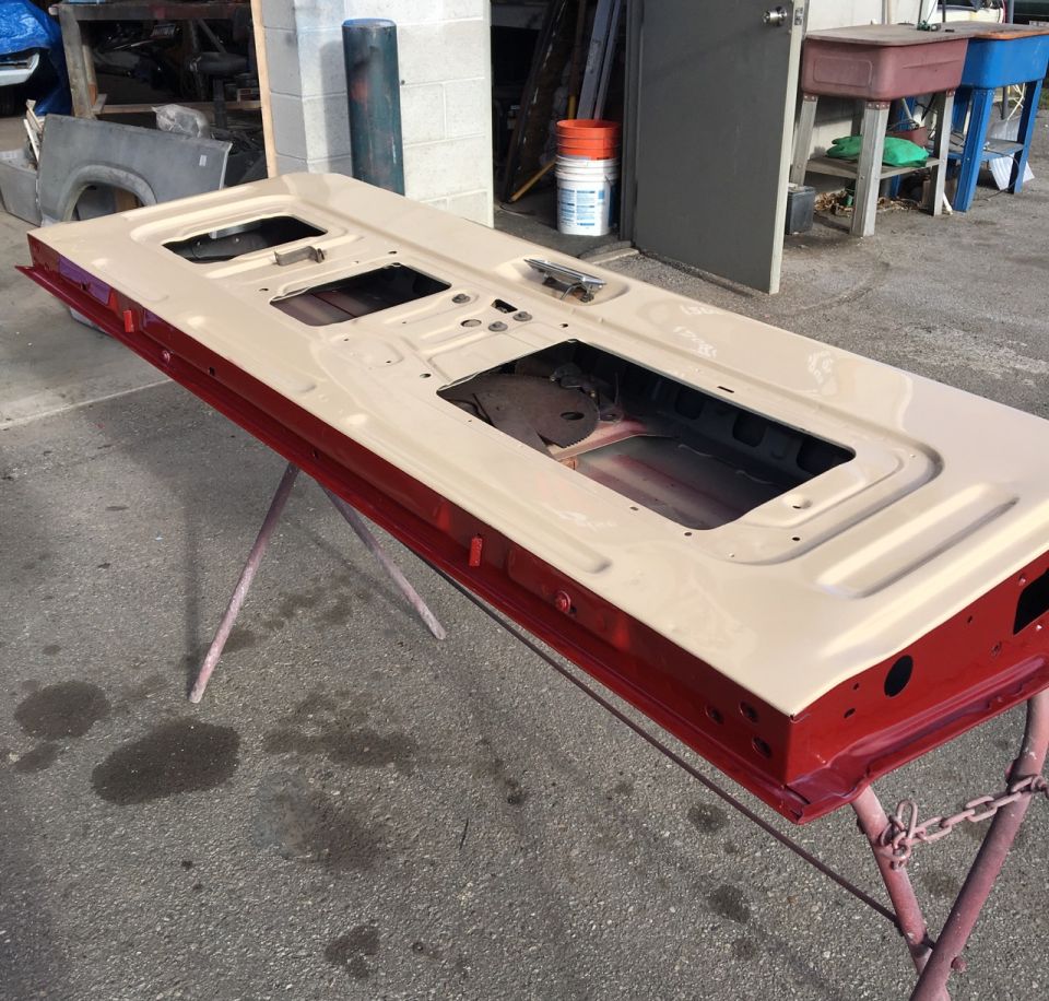 Cream and red painted vehicle tailgate on a stand