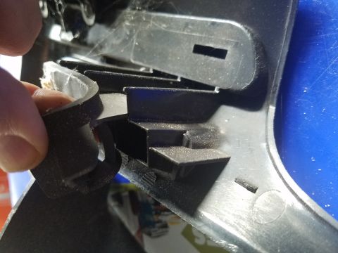 1994 Ford Bronco - Photograph of a plastic trim clip and panel, not a technical document.