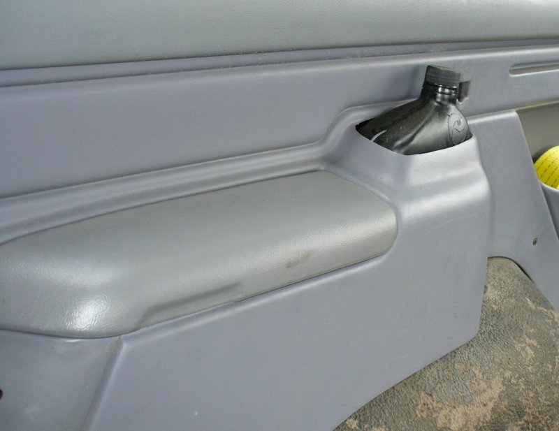 Rear seat belt storage cubby.
