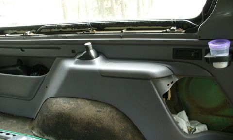 1992 Ford Bronco - Rear seat belt storage cubby and pry bar mount.