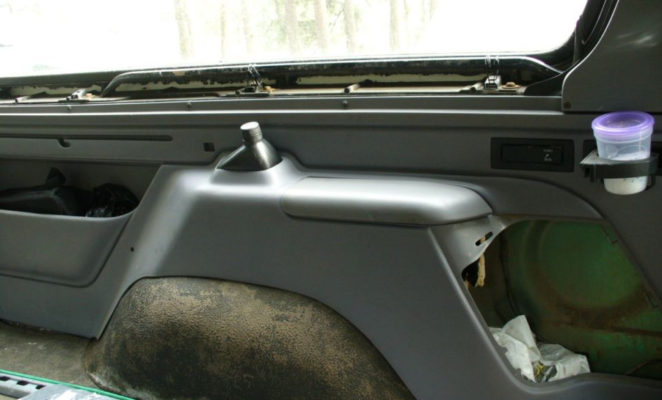 Rear seat belt storage cubby and pry bar mount.