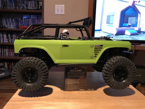 1989 Ford Bronco - A remote-controlled rock crawler toy with various sponsor decals is displayed indoors.