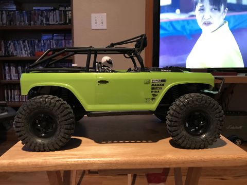 1989 Ford Bronco - This RC rock crawler has a roll cage and large off-road tires, viewed from the side.