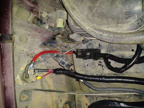 1996 Ford Bronco - Close-up view of engine bay wiring and components, showing electrical connections and hoses.