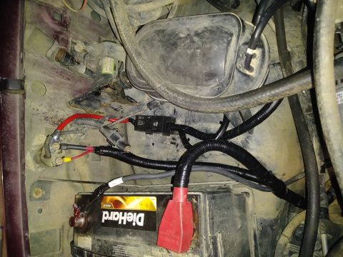 1996 Ford Bronco - Close-up of engine bay wiring and battery, showing electrical connections and routing.