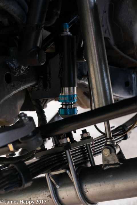 1989 Ford Bronco - Close-up of a suspension shock absorber with blue adjusters and "KING" branding.
