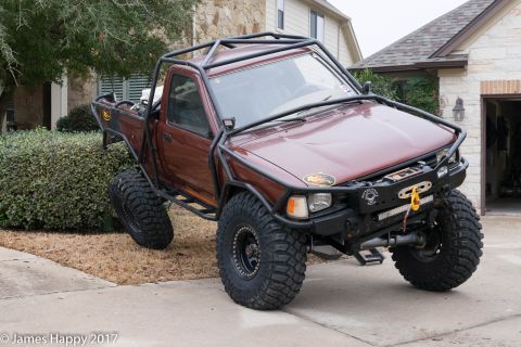 1989 Ford Bronco - This heavily modified pickup truck features a custom roll cage and large off-road tires, suggesting it is not a stock 1989 Ford Bronco.