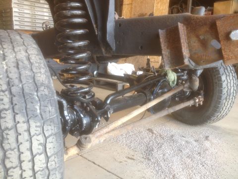1979 Ford Bronco - Close-up view of the front suspension and chassis of a 1979 Ford Bronco during restoration.