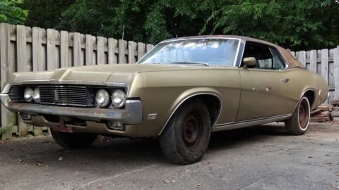 1969 Mercury Cougar - This 1969 Mercury Cougar coupe shows signs of wear and tear, with a weathered exterior and older wheels.