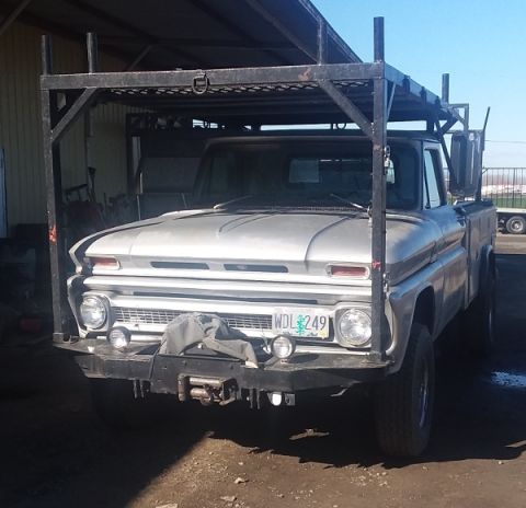 1993 Ford Bronco - Front view of a silver pickup truck equipped with a utility rack. The license plate reads WDL 249.