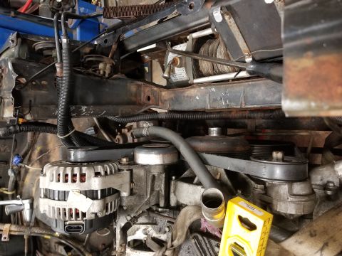 1991 Mitsubishi Montero - Close-up view of the engine bay components, including the alternator and a winch.