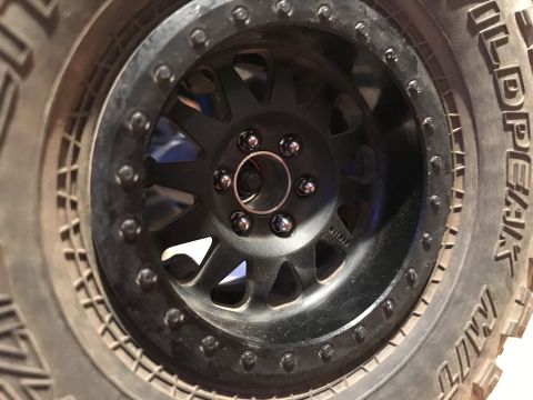 1989 Ford Bronco - Close-up view of a black aftermarket wheel and BFGoodrich tire, showing the tread pattern and wheel details.