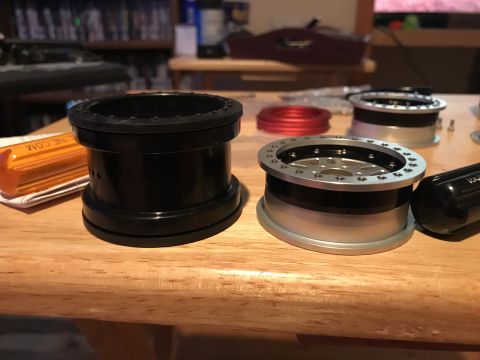1989 Ford Bronco - Wheel adapters are shown on a table, with other parts visible in the background.