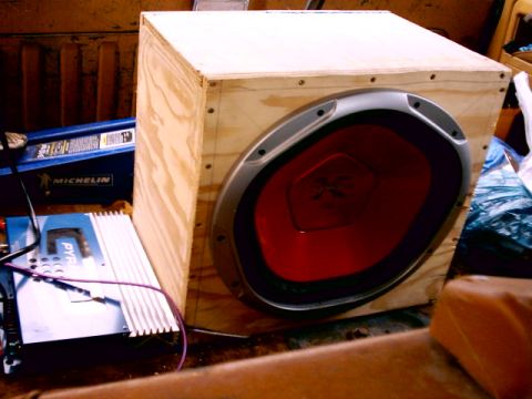 1980 Ford Bronco - A subwoofer, amplifier, and blue container are visible in what appears to be the cargo area of a vehicle.