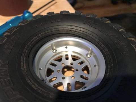 1989 Ford Bronco - Close-up of an RC car tire and wheel assembly, showing tire brand and wheel details.