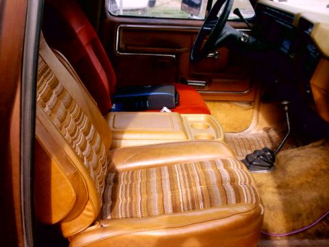 1980 Ford Bronco - Interior view of a 1980 Ford Bronco, showing the bench seat, console, and shifter.