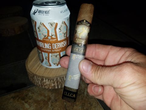 2018 Ford Bronco - A hand holds a cigar next to a can of Monday Night Brewing's Whirling Dervish Coffee Stout.