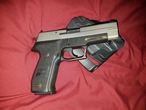 2018 Ford Bronco - A SIG Sauer pistol is shown in its holster on a red fabric background.