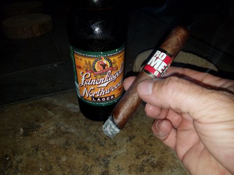 2018 Ford Bronco - A hand holds a cigar and a bottle of Leinenkugel's Northwoods Lager sits nearby.
