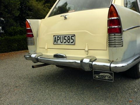 1962 MG B - The rear of a vintage car shows chrome accents and a license plate, but its model year is not visually identifiable.