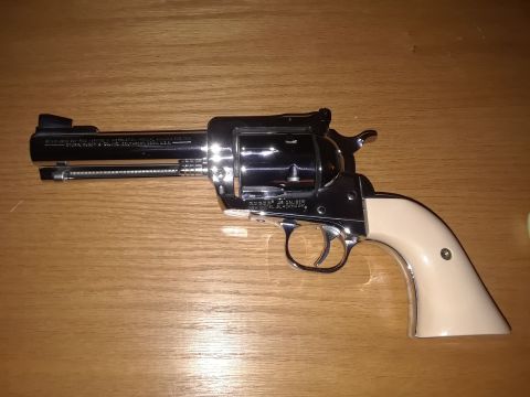 1994 Ford Bronco - A chrome-plated revolver with ivory-colored grips rests on a wooden table.