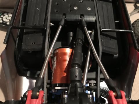 1989 Ford Bronco - Close-up of an RC car's chassis, highlighting the motor and suspension system.