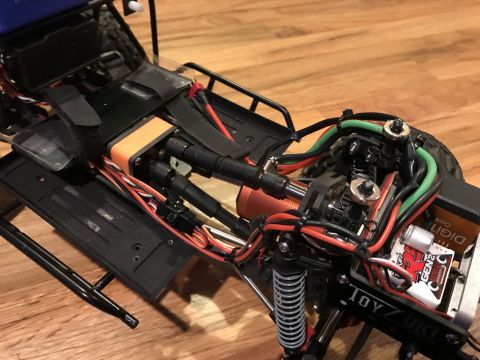 1989 Ford Bronco - Close-up view of the interior of a radio-controlled car, revealing its complex wiring and mechanical parts.
