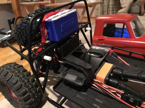 1989 Ford Bronco - Close-up of a modified RC rock crawler chassis with a cooler mounted on the roll cage.