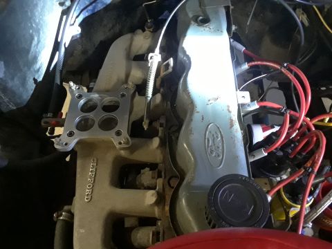 1985 Ford Bronco - Close-up of an engine bay showing a Ford valve cover and a Clifford intake manifold, with spark plug wires visible.