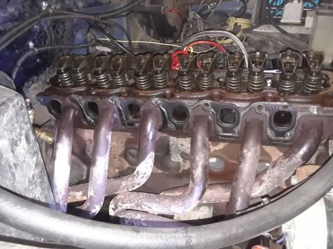 1985 Ford Bronco - The internal components of an engine's cylinder head and exhaust manifold are visible in this close-up shot.