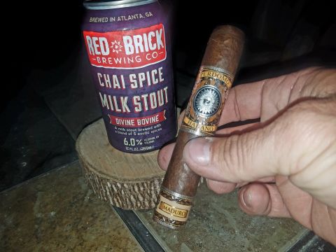 2018 Ford Bronco - A Perdomo Maduro cigar and a can of Red Brick Brewing Co. Chai Spice Milk Stout are displayed on a wooden coaster.