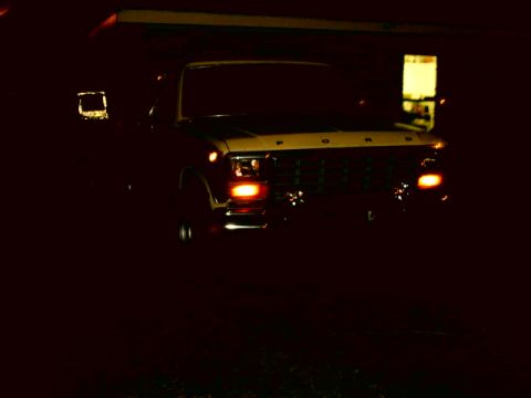 1980 Ford Bronco - A dark 1978 Ford F-Series truck is seen from the front at night.