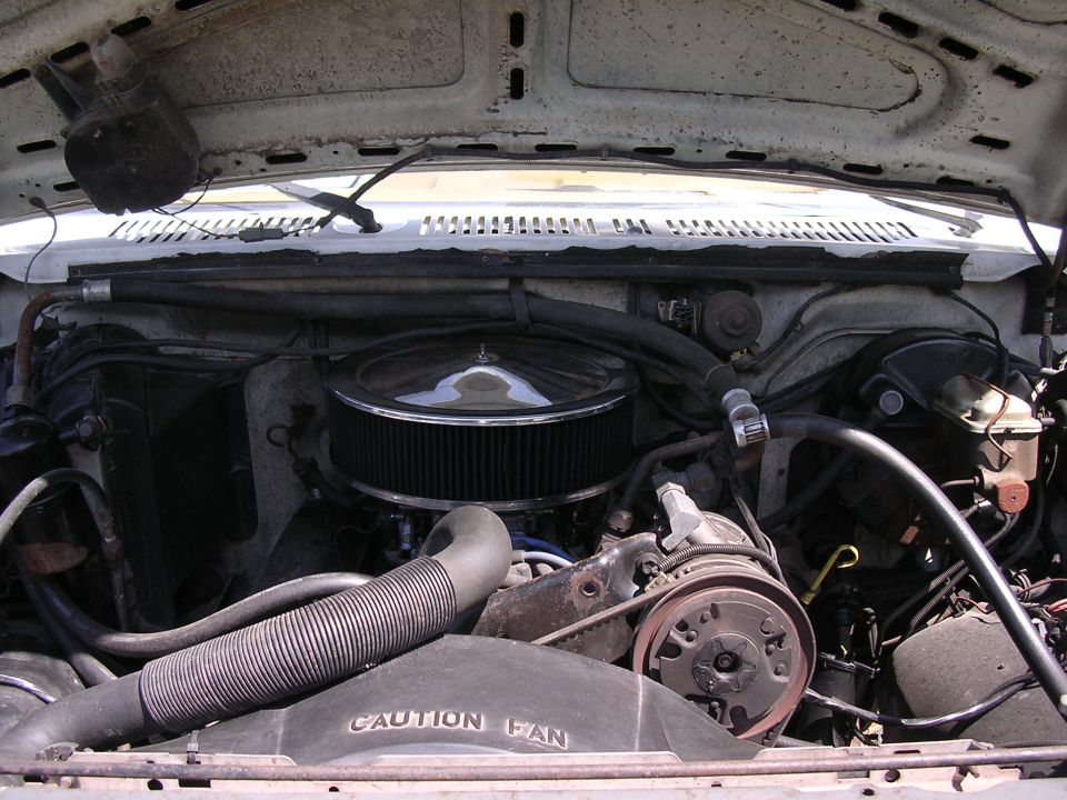 Ford V8 engine bay with chrome round air cleaner and CAUTION FAN shroud