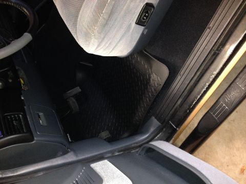 1995 Ford Bronco - The interior of a vehicle is shown, focusing on the floor mats and seating area.
